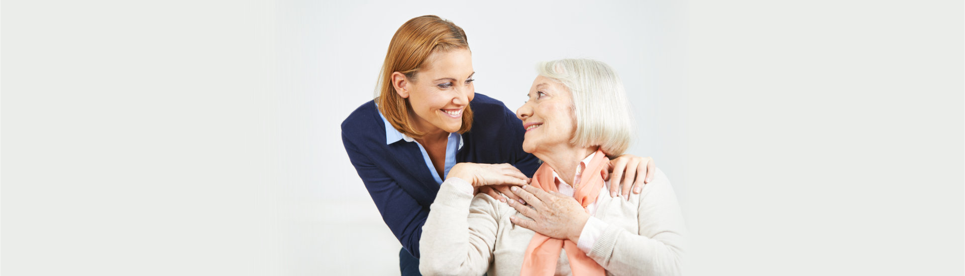 caregive and elderly patient smiling