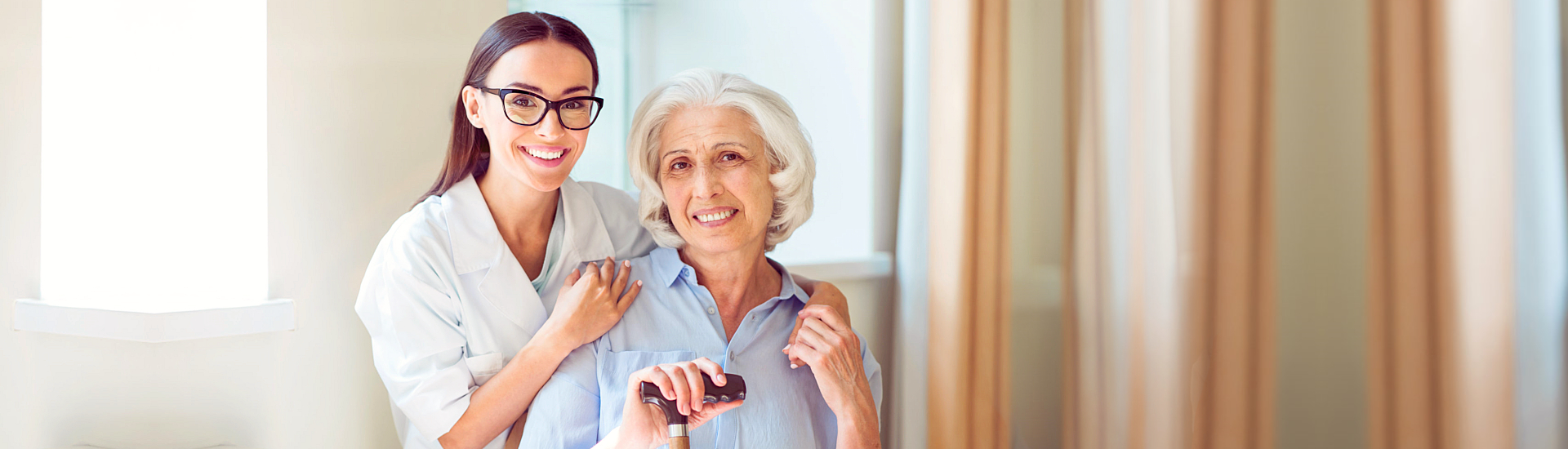 Caregiver and senior smiling