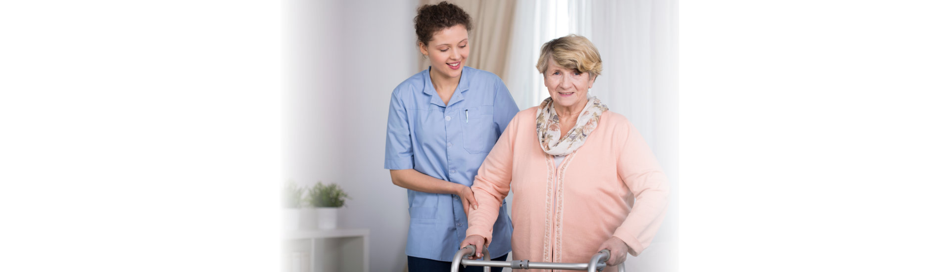 caregiver assisting her patient in walking