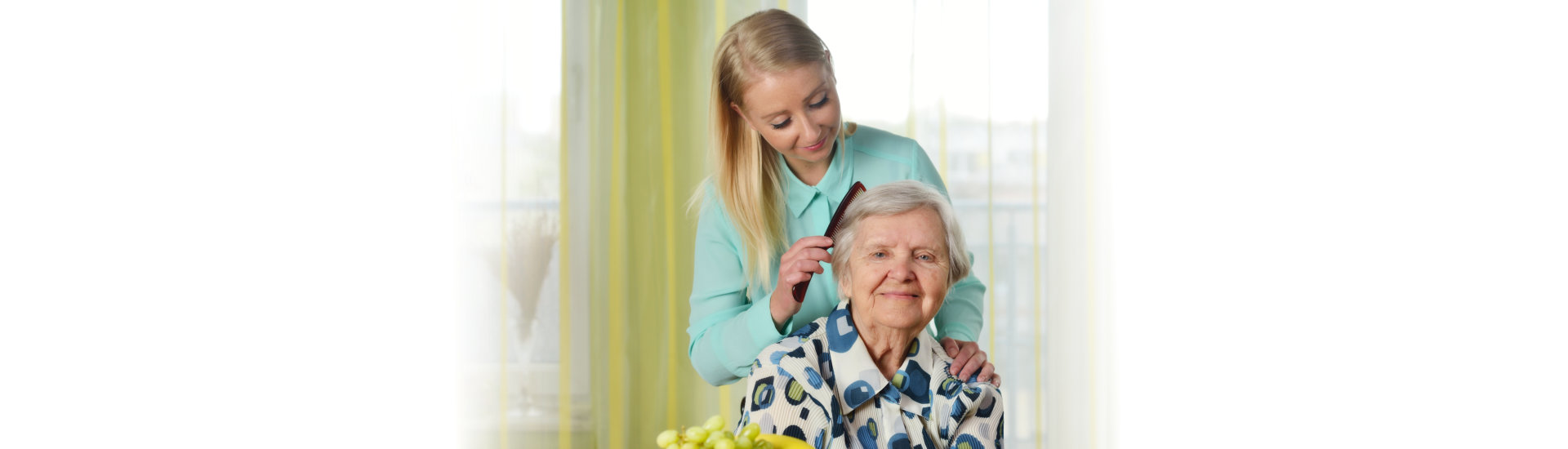 caregiver combing the hair of her patient
